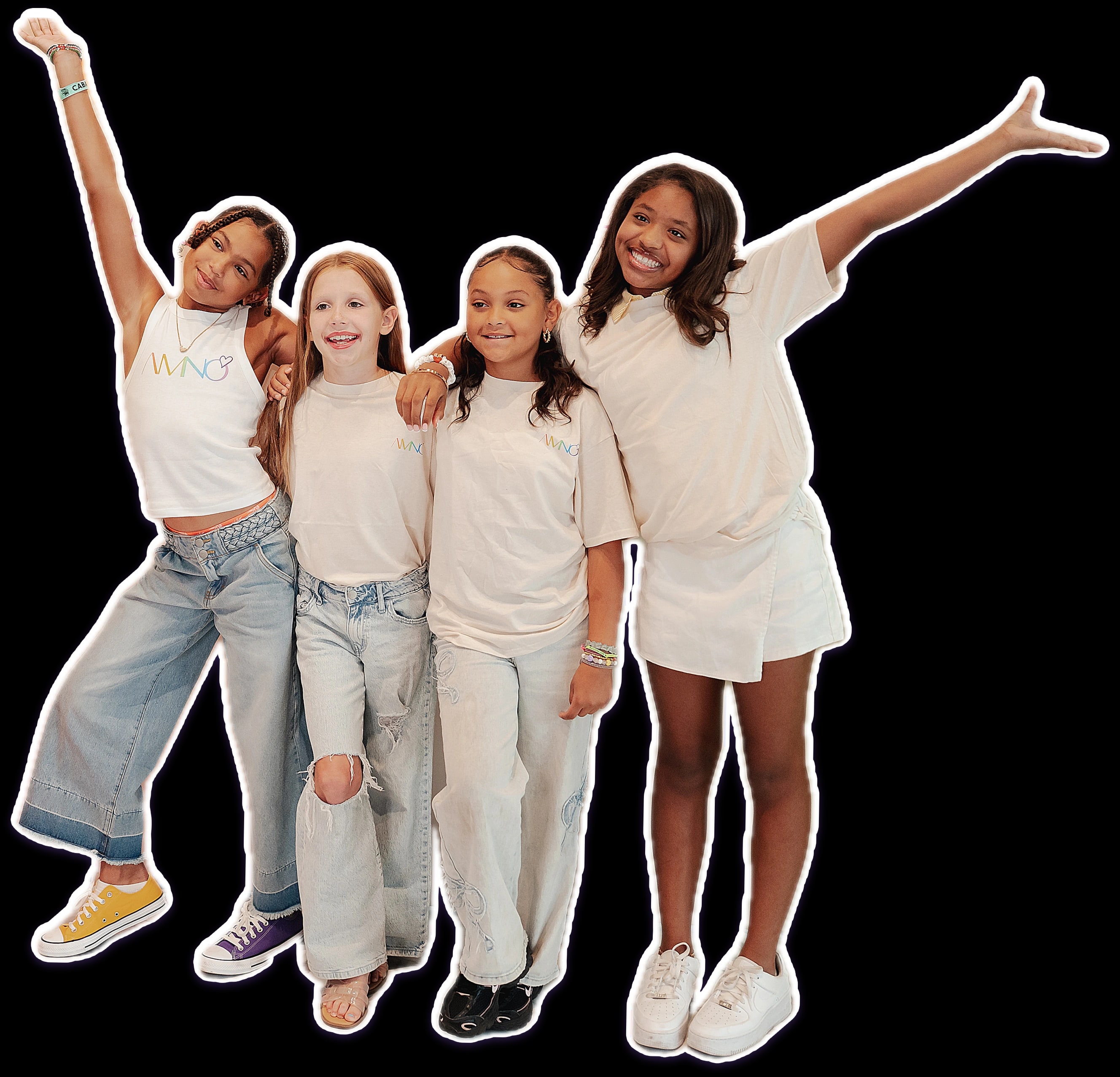 Four AMNO girls arm in arm, two throwing their arms up in celebration